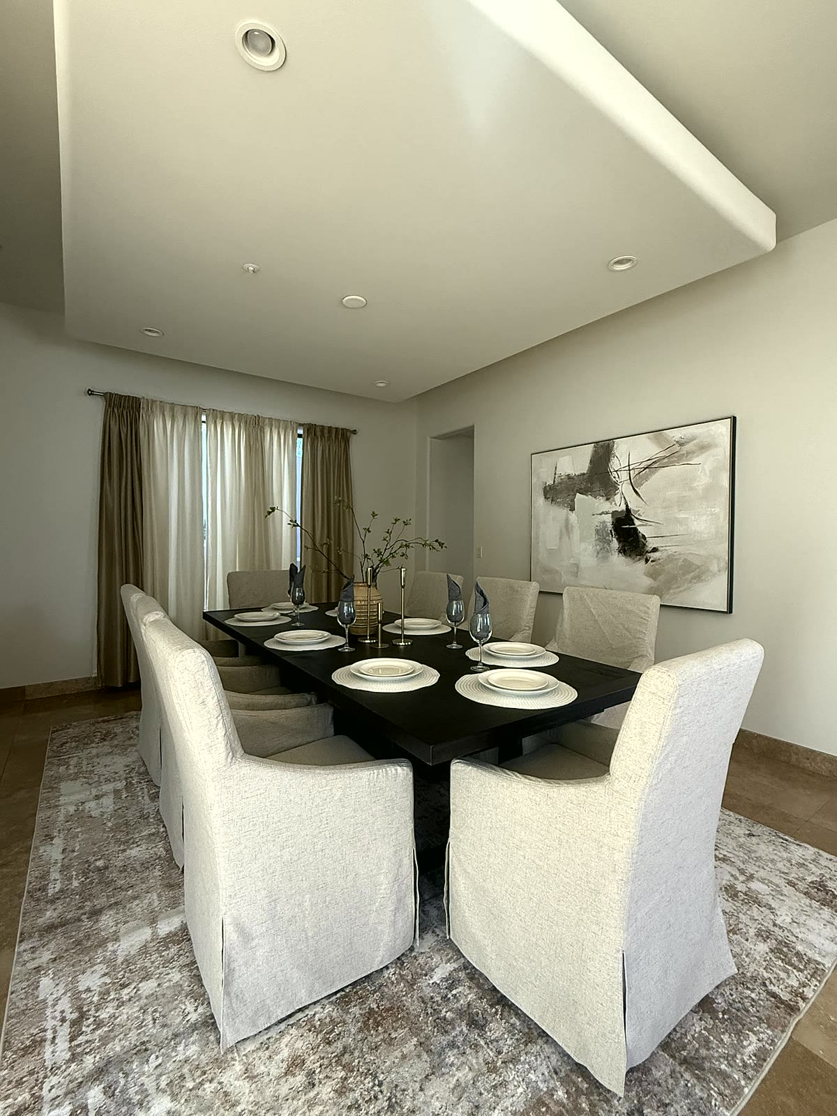 Luxury Scottsdale formal dining room staged with a set table and upholstered chairs