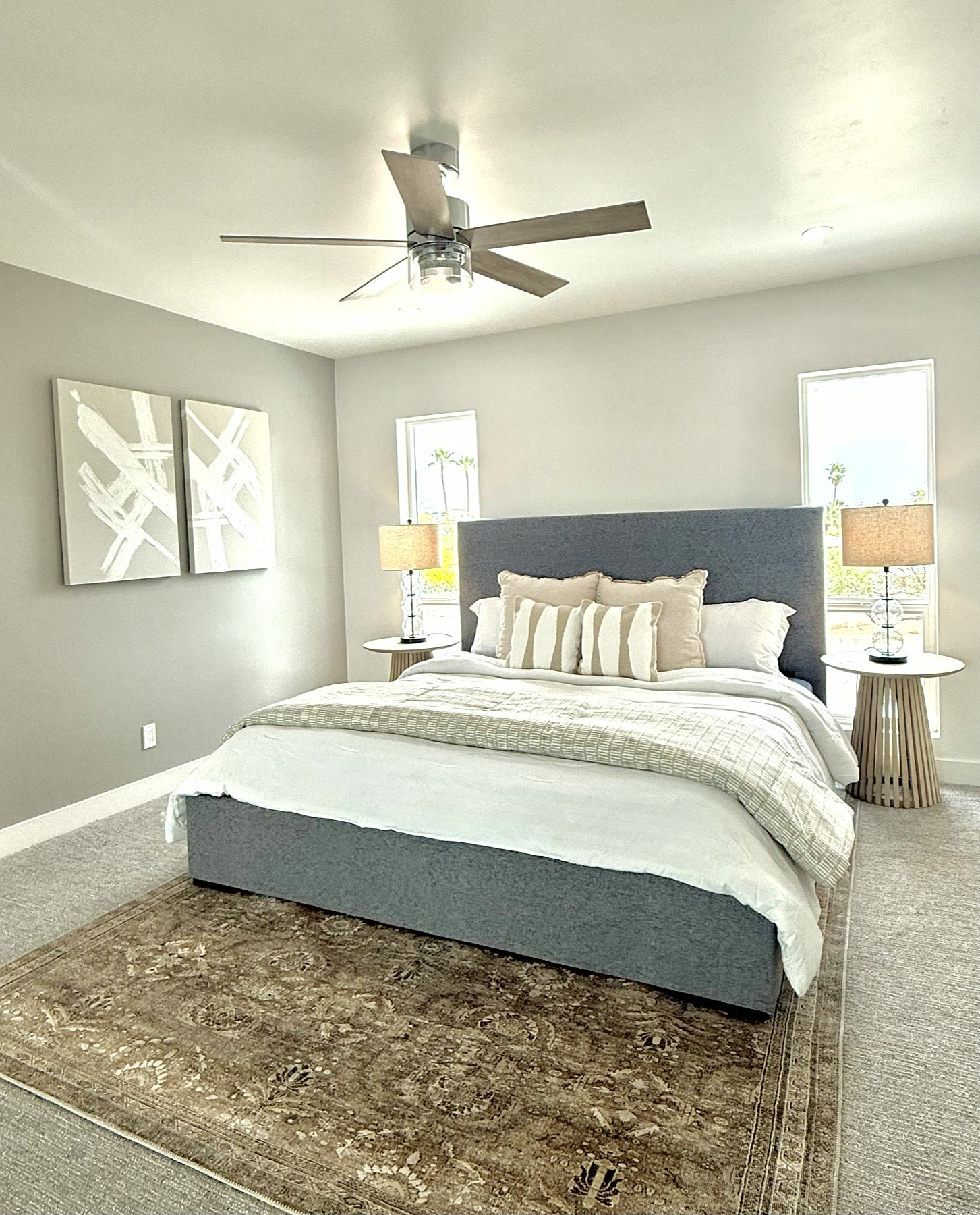 Staged bedroom with layered neutral bedding