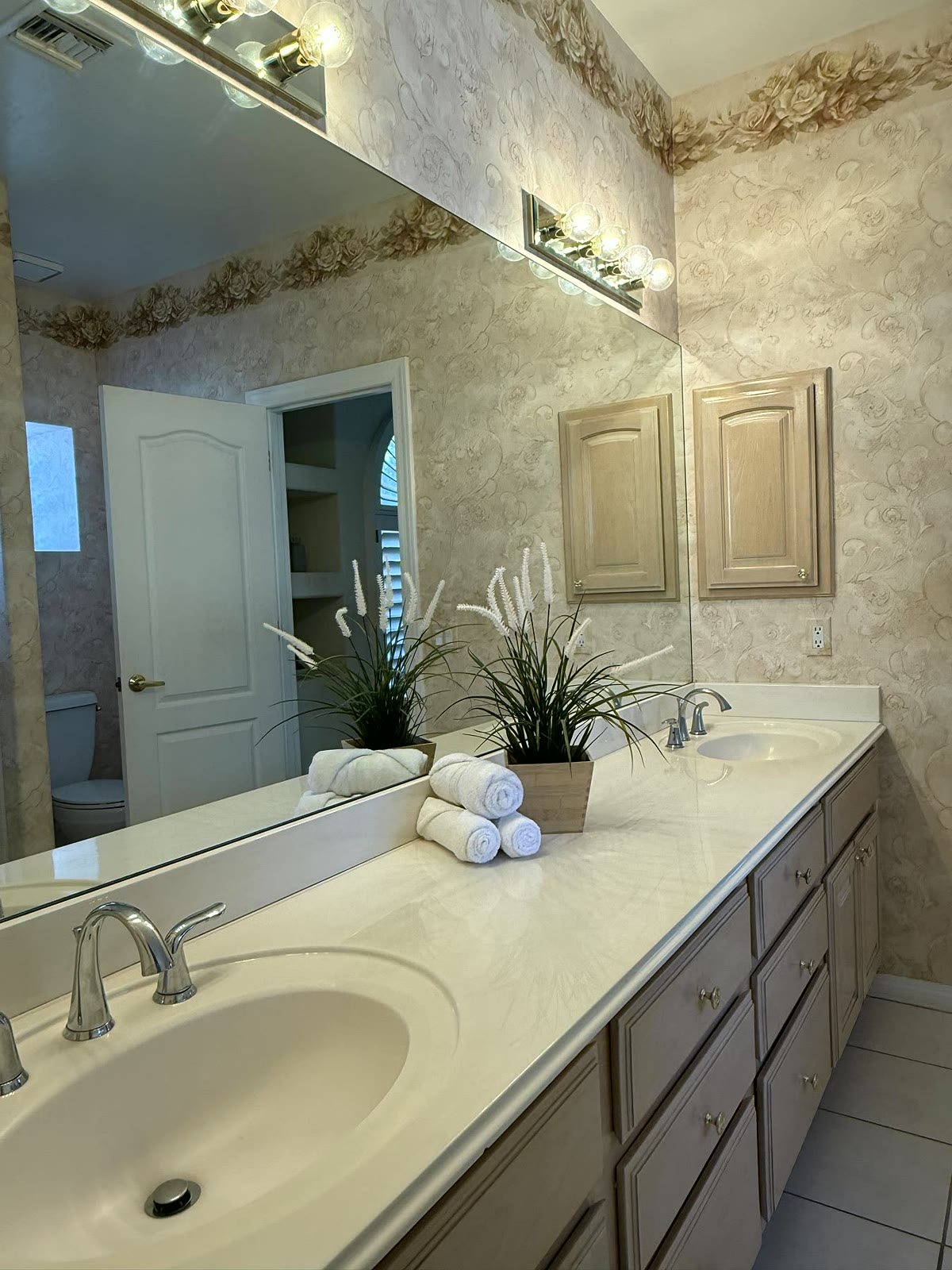Scottsdale bathroom styled with a vanity, mirror, and warm finishing details