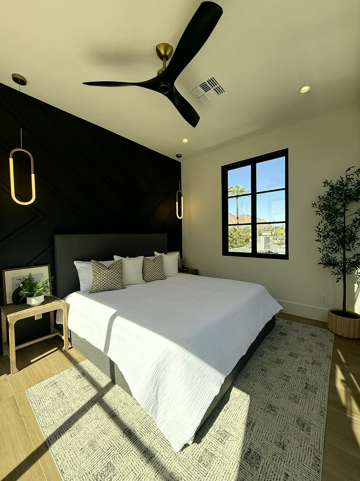 Scottsdale bedroom staged with a bed, bench seating, and window-facing natural light